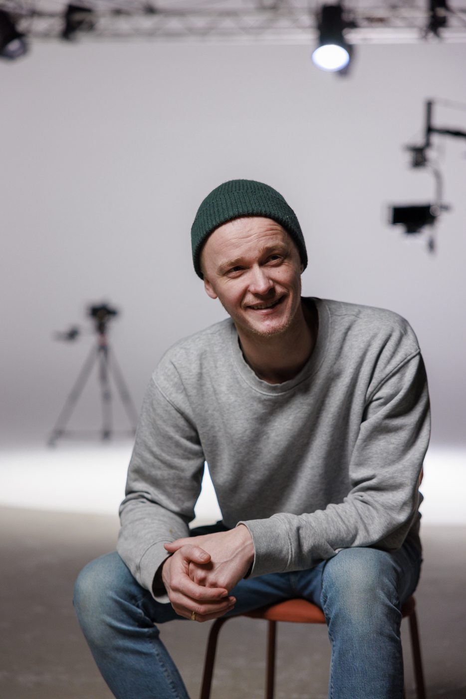 Thomas Holmstrøm, founder of Nextnew Studio, sitting on set between takes